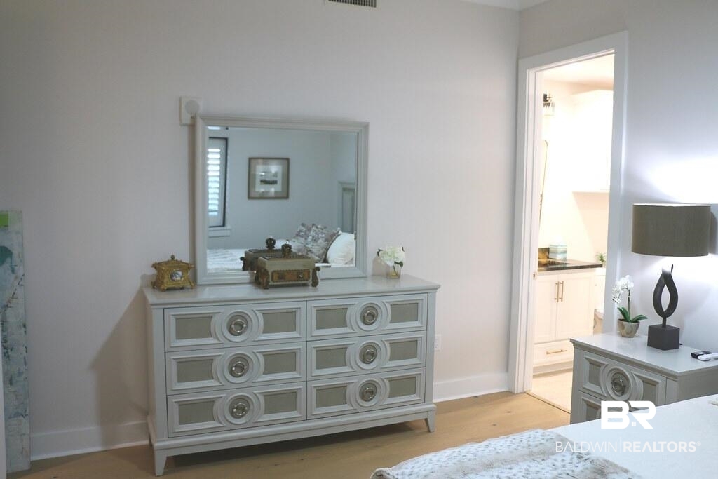 18269 Colony Drive, Unit 803 Fairhope, AL 36532 - Photo 21 of 27 Bedroom with ensuite bathroom and light wood-style floors