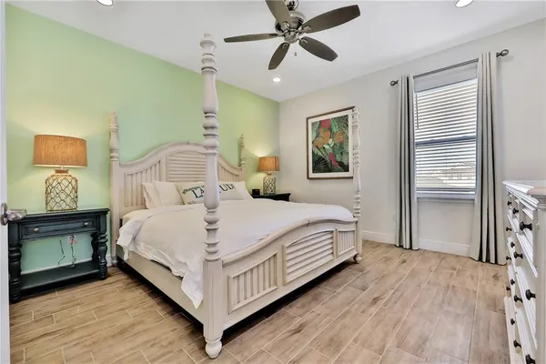 a bedroom with a bed a flat screen tv and a couch