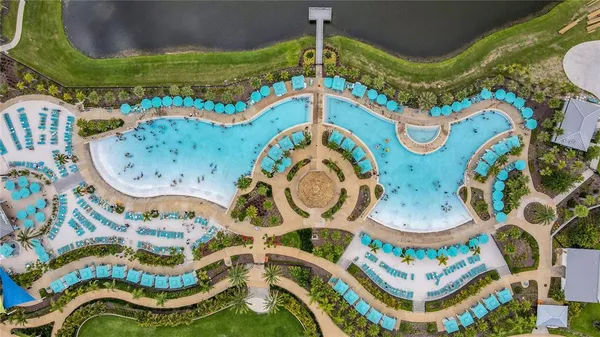 a view of residential houses with swimming pool and lake view