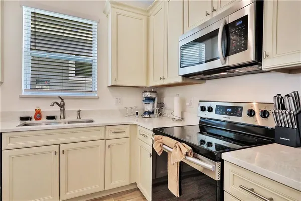 a kitchen with stainless steel appliances granite countertop a stove and a microwave