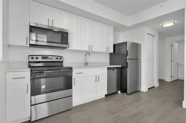 a kitchen with a stove microwave and refrigerator