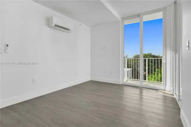 a view of a room with wooden floor and windows