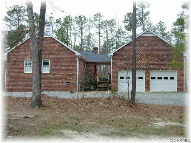 13570 Spring Run Road Midlothian, VA 23112 - Photo 3 of 10 a front view of a house with a yard and garage