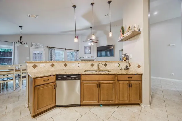 a kitchen with a sink and stove