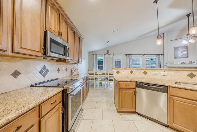 a kitchen with a stove sink and cabinets