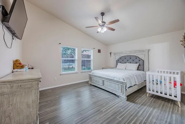 a bedroom with a bed and wooden floor