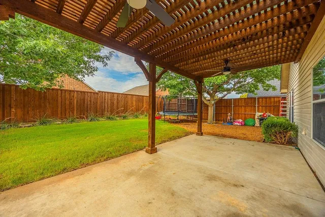a view of a backyard with wooden fence and floor