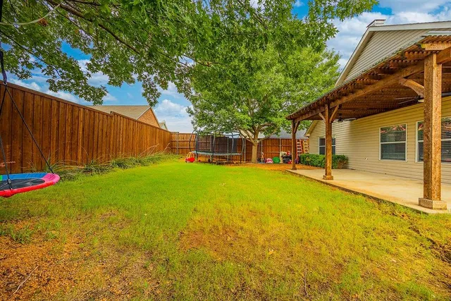 a view of a house with backyard and porch