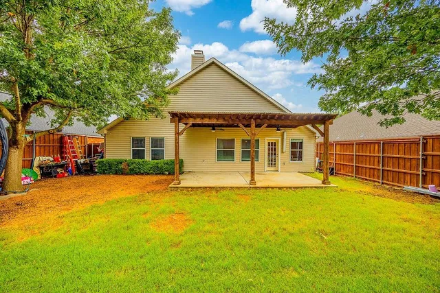 a view of a house with a yard and sitting area