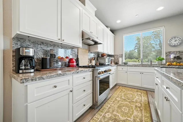 a view of a hallway with wooden floor and stairs
