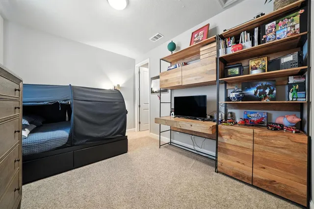a view of a bedroom with furniture and a window