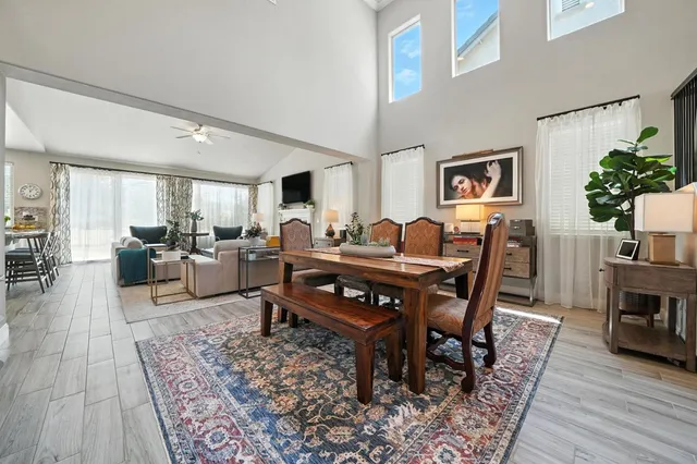 a dining room with furniture entryway and wooden floor