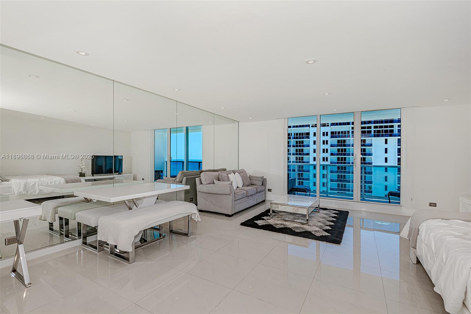 2301 Collins Avenue, Unit 1211 Miami Beach, FL 33139 - Photo 1 of 24 a living room with furniture and a table
