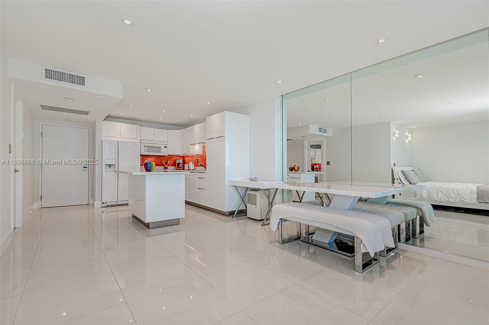 2301 Collins Avenue, Unit 1211 Miami Beach, FL 33139 - Photo 11 of 24 a spacious bedroom with a bed and a chandelier