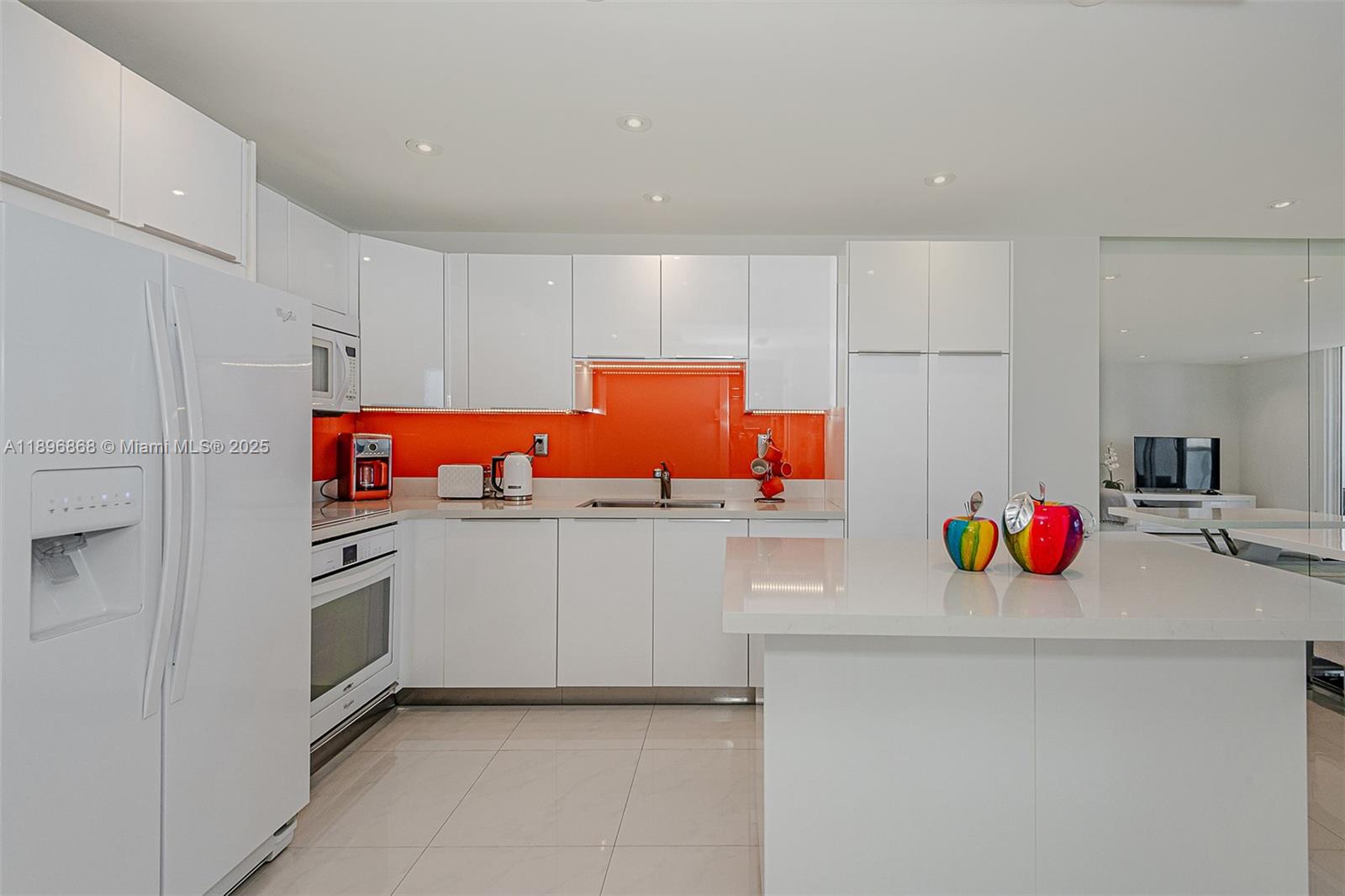 2301 Collins Avenue, Unit 1211 Miami Beach, FL 33139 - Photo 14 of 24 a kitchen with white cabinets and white appliances