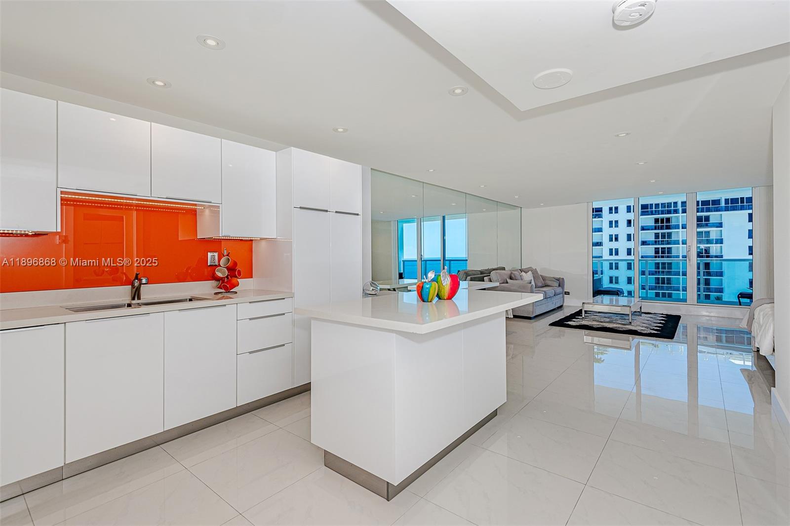 2301 Collins Avenue, Unit 1211 Miami Beach, FL 33139 - Photo 16 of 24 a kitchen with granite countertop cabinets a sink a window and stainless steel appliances