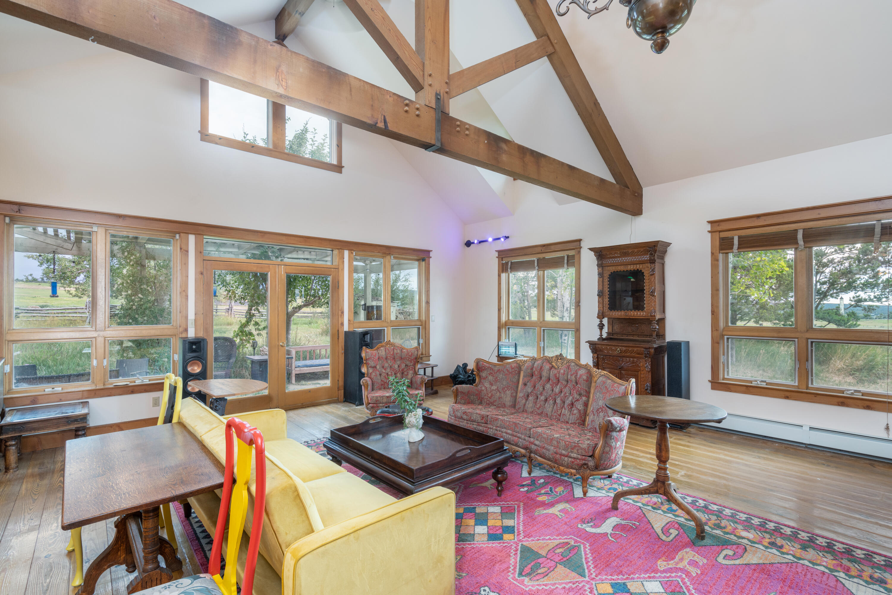 1226 County Rd X45 Norwood, CO 81423 - Photo 12 of 32 a living room with furniture and a floor to ceiling window