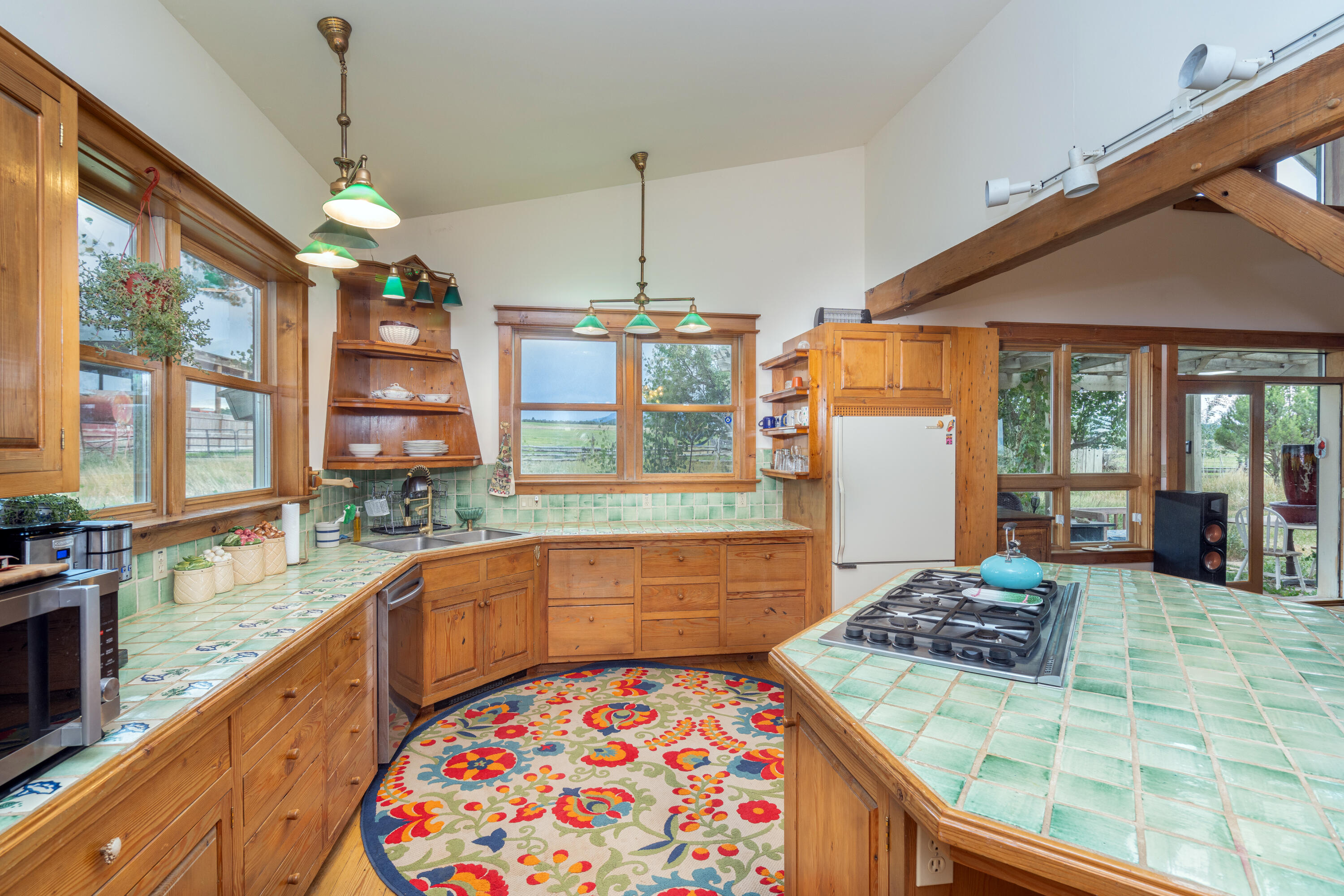 1226 County Rd X45 Norwood, CO 81423 - Photo 10 of 32 a large kitchen with kitchen island granite countertop a large window in it