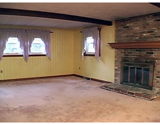 14 Governor Fuller Road Billerica, MA 01821 - Photo 8 of 12 a view of an empty room with a fireplace and a window