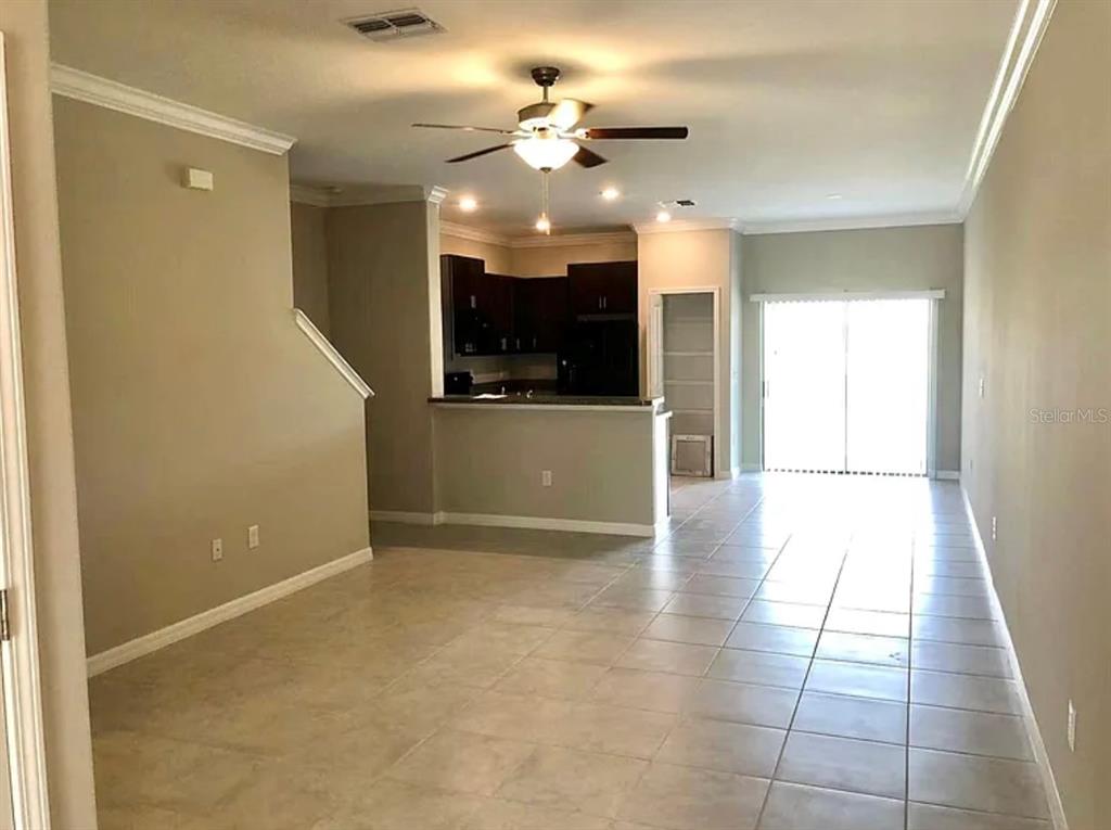 11768 Dumaine Valley Road Riverview, FL 33579 - Photo 2 of 6 wooden floor in an empty room with a kitchen