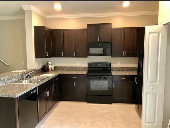 a kitchen with a refrigerator and a sink