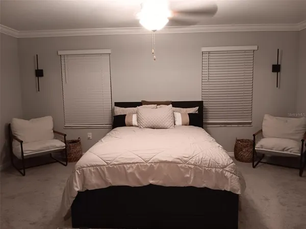 a bedroom with a bed and a couch