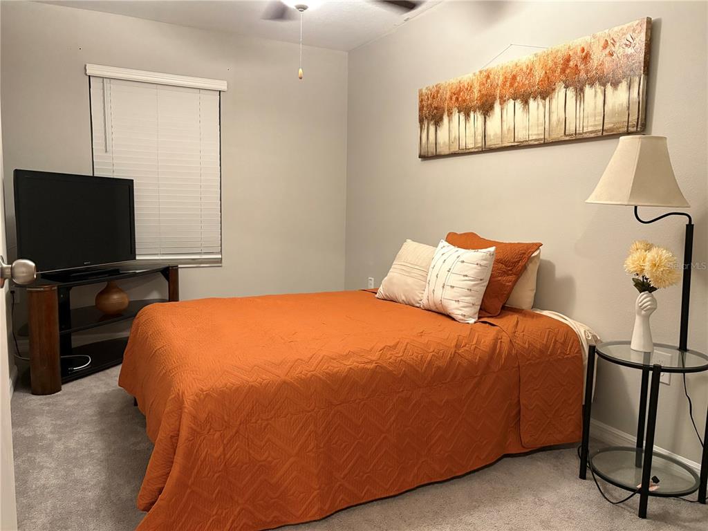 11768 Dumaine Valley Road Riverview, FL 33579 - Photo 6 of 6 a bedroom with a bed and a flat screen tv