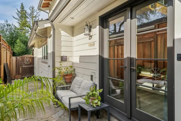 a kitchen with stainless steel appliances granite countertop a sink dishwasher and wooden cabinets with wooden floor