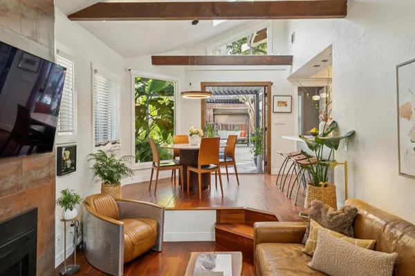 a balcony with wooden floor and outdoor seating