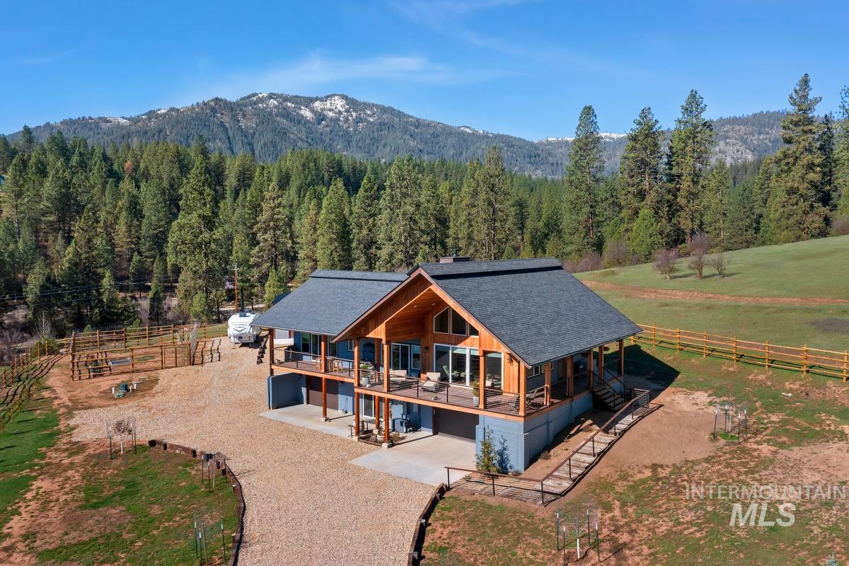21 Open Road Garden Valley, ID 83622 - Photo 1 of 49 Rear view of house with a garage, a shingled roof, a wooded view, and driveway