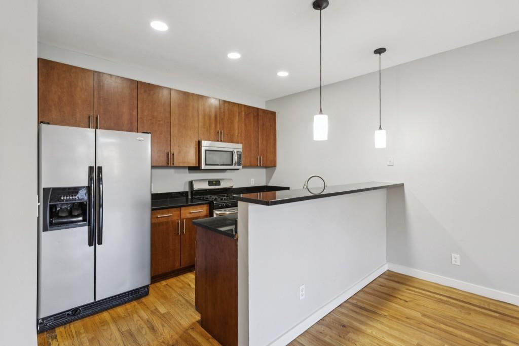 238 Walker Street Southwest, Unit 39 Atlanta, GA 30313 - Photo 14 of 35 a kitchen with stainless steel appliances a refrigerator sink and microwave
