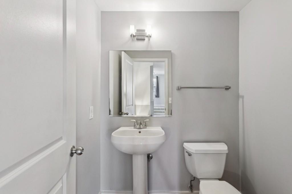 238 Walker Street Southwest, Unit 39 Atlanta, GA 30313 - Photo 18 of 35 a bathroom with a toilet sink and mirror