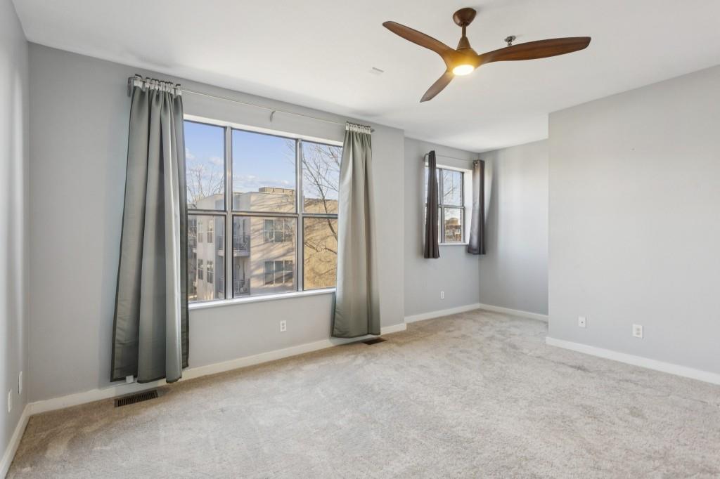 238 Walker Street Southwest, Unit 39 Atlanta, GA 30313 - Photo 19 of 35 an empty room with windows and closet