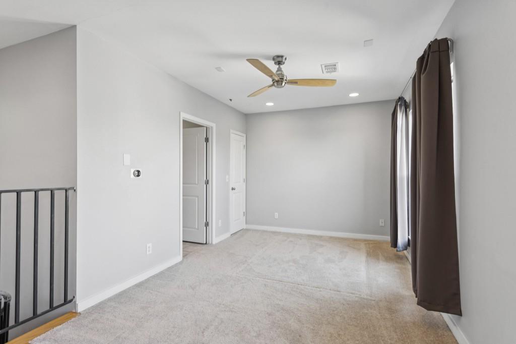 238 Walker Street Southwest, Unit 39 Atlanta, GA 30313 - Photo 27 of 35 an empty room with a windows and ceiling fan