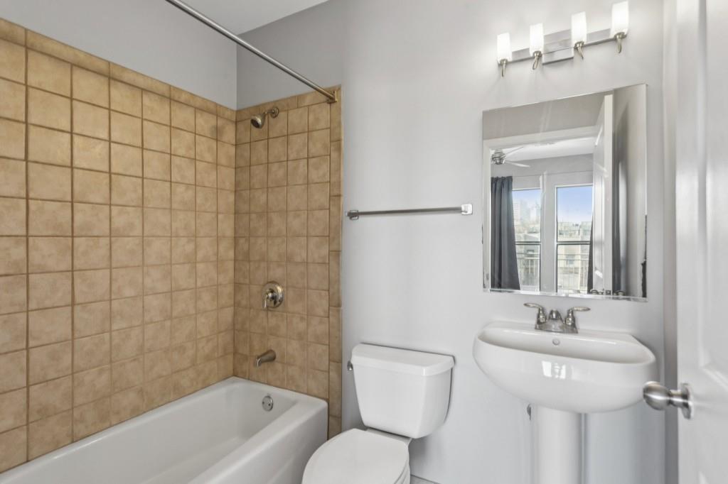 238 Walker Street Southwest, Unit 39 Atlanta, GA 30313 - Photo 29 of 35 a bathroom with a sink a toilet and shower
