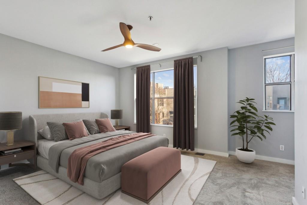 238 Walker Street Southwest, Unit 39 Atlanta, GA 30313 - Photo 3 of 35 a bedroom with a large bed and a potted plant