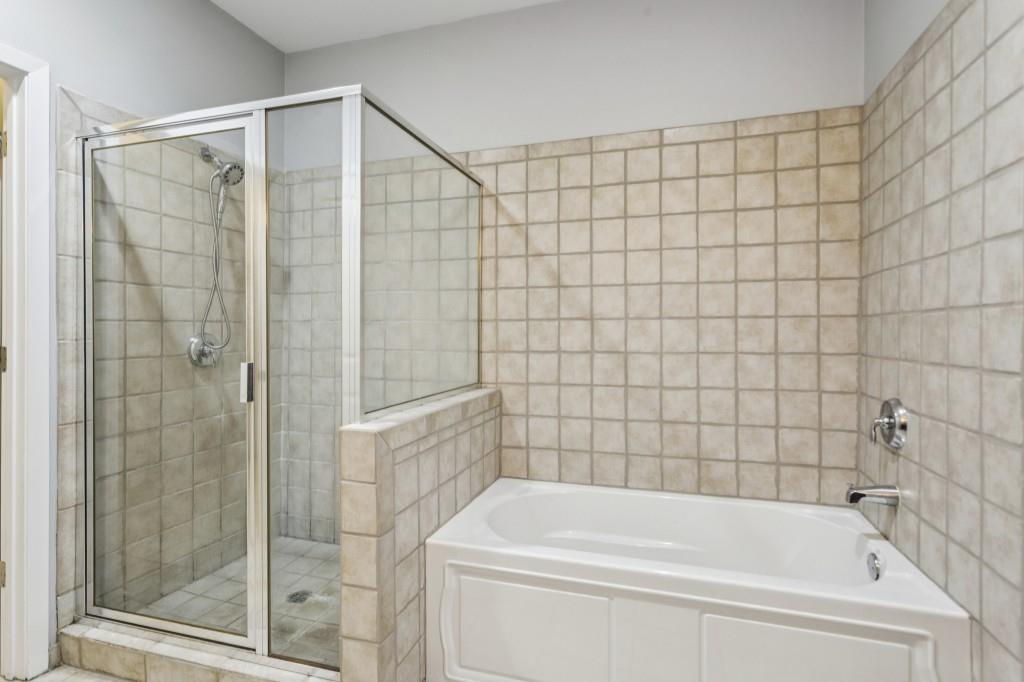 238 Walker Street Southwest, Unit 39 Atlanta, GA 30313 - Photo 4 of 35 a bathroom with a bathtub and shower