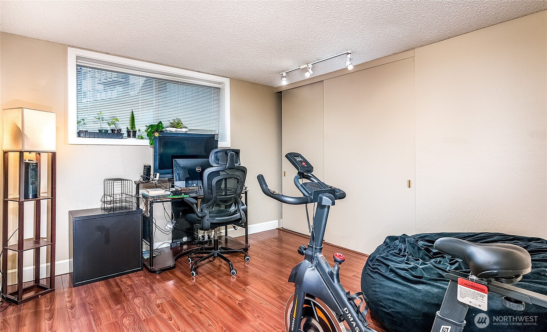 3722 27th Place West, Unit 101 Seattle, WA 98199 - Photo 12 of 17 a view of a workspace with furniture and wooden floor
