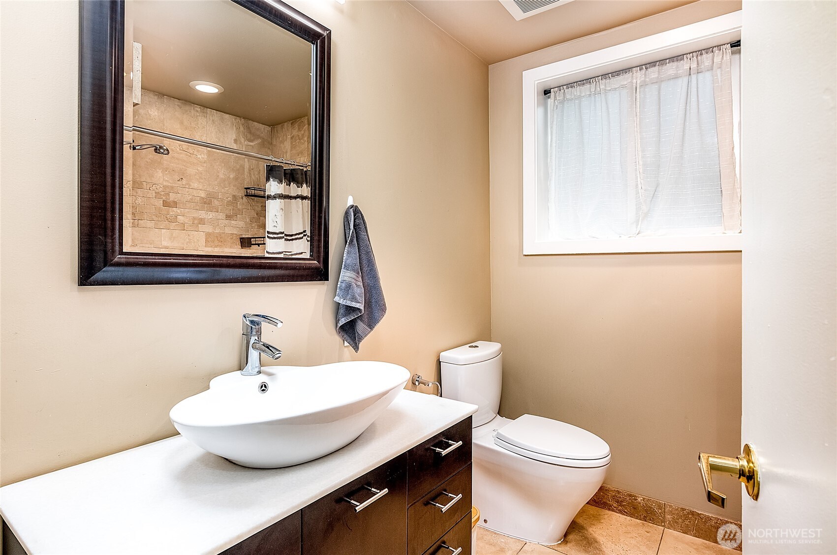 3722 27th Place West, Unit 101 Seattle, WA 98199 - Photo 13 of 17 a bathroom with a toilet a sink and mirror
