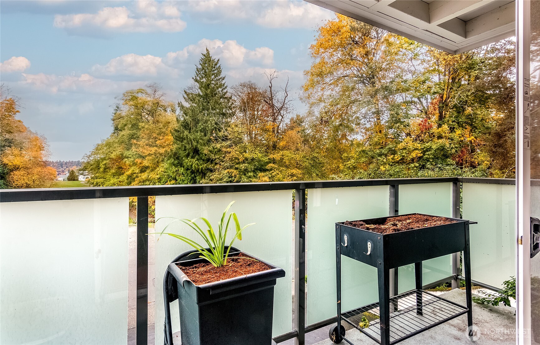 3722 27th Place West, Unit 101 Seattle, WA 98199 - Photo 15 of 17 a view of a chairs and table in a balcony