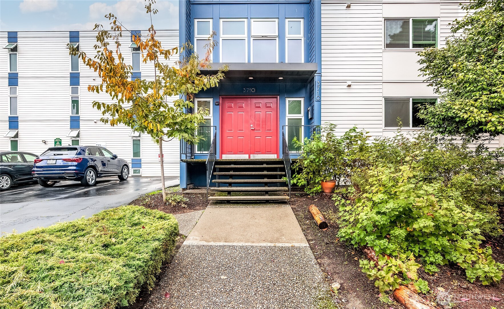 3722 27th Place West, Unit 101 Seattle, WA 98199 - Photo 2 of 17 a view of a car park in front of a building