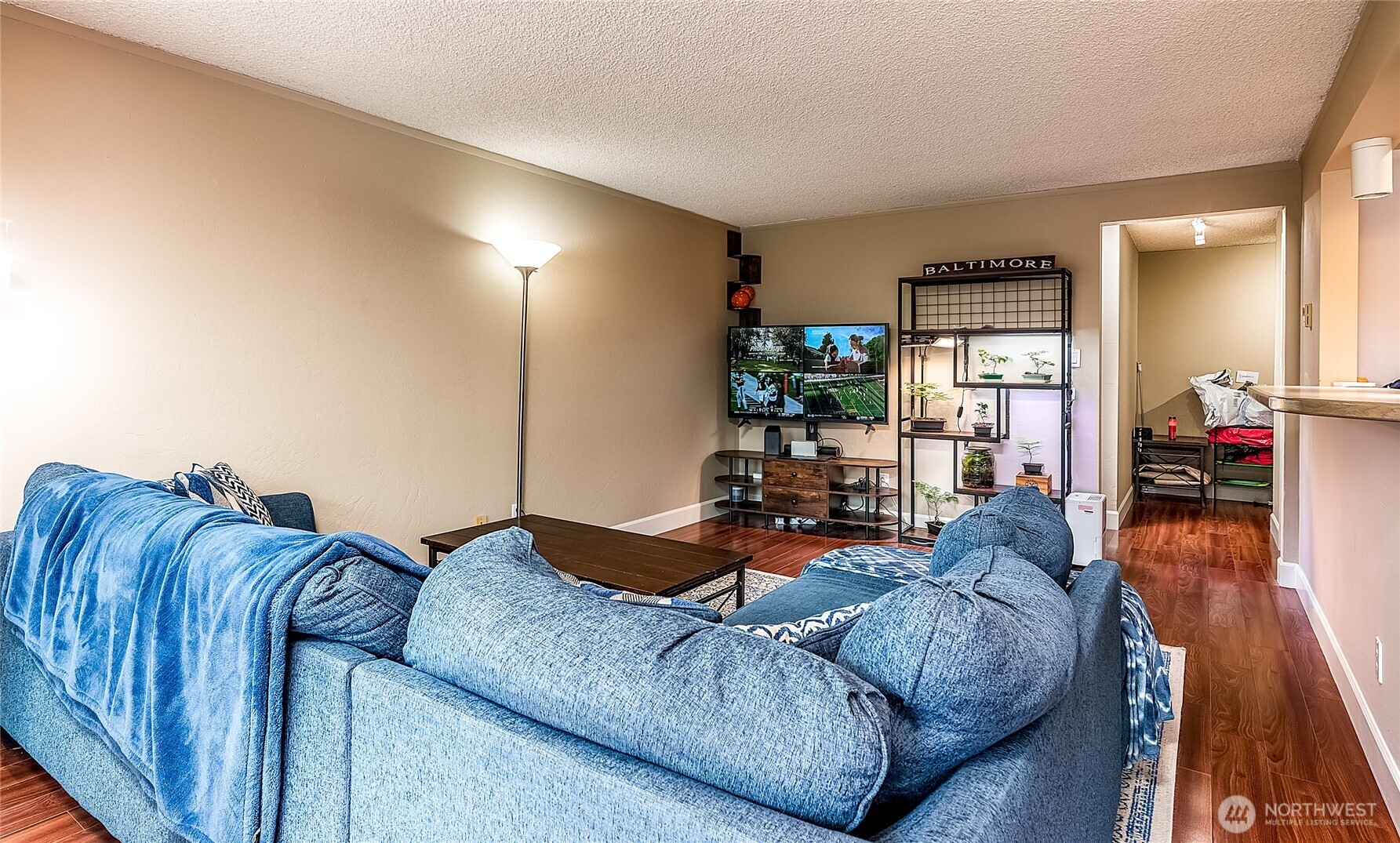 3722 27th Place West, Unit 101 Seattle, WA 98199 - Photo 6 of 17 a living room with furniture and a wooden floor