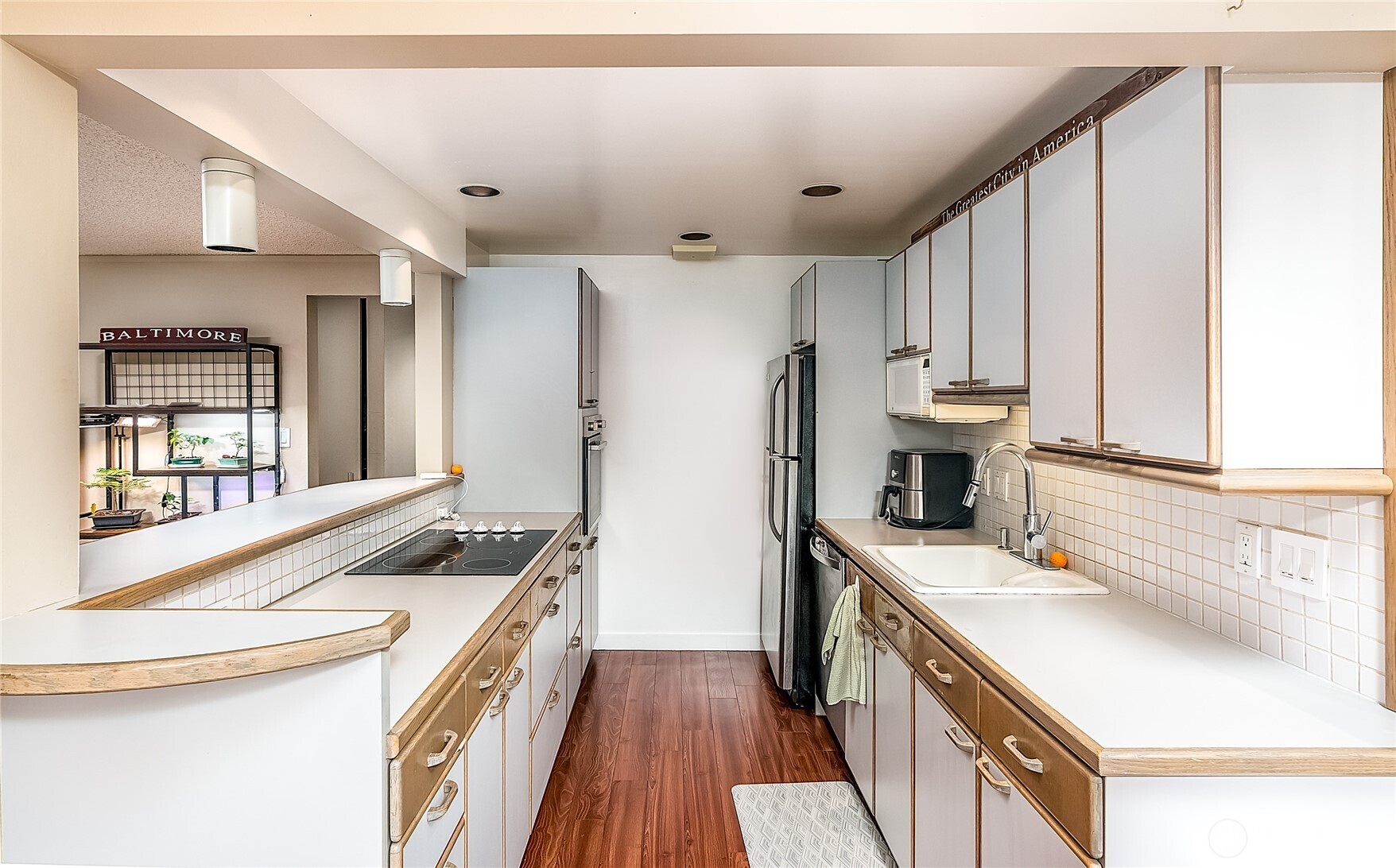 3722 27th Place West, Unit 101 Seattle, WA 98199 - Photo 10 of 17 a kitchen that has a sink a stove and a refrigerator