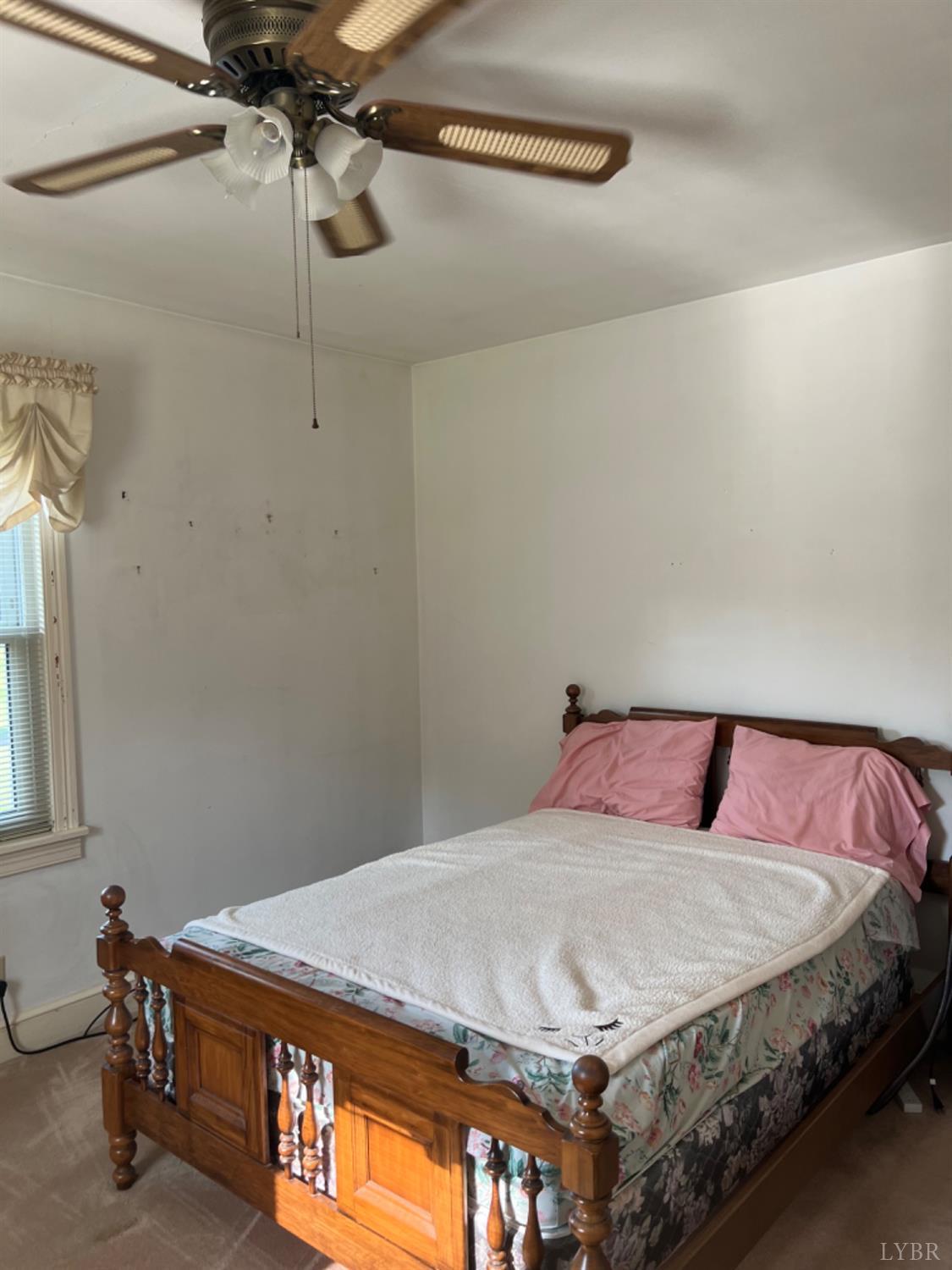 1649 Grit Road Hurt, VA 24563 - Photo 16 of 25 a bedroom with a bed and a chandelier