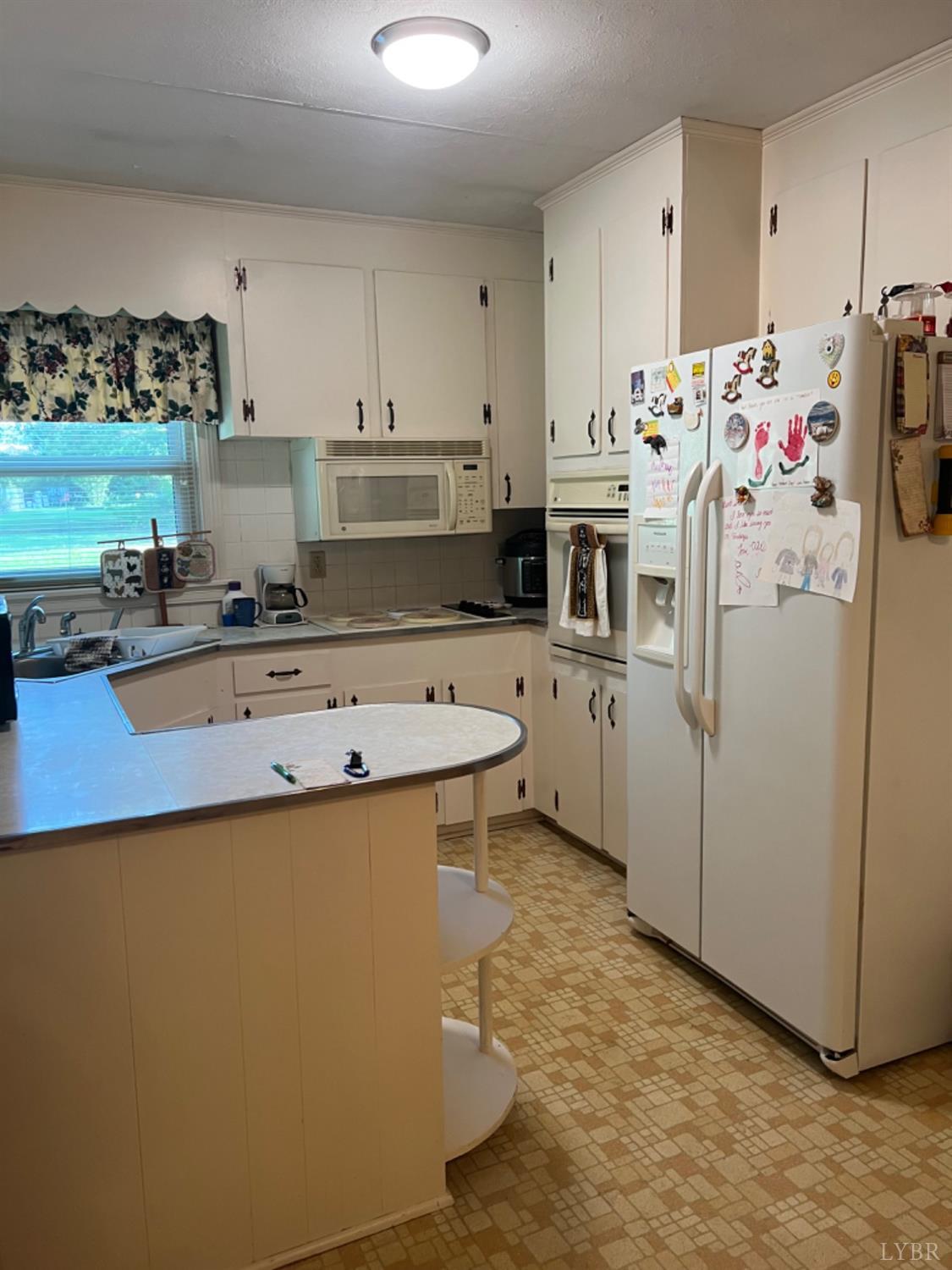 1649 Grit Road Hurt, VA 24563 - Photo 3 of 25 a kitchen with refrigerator and cabinets