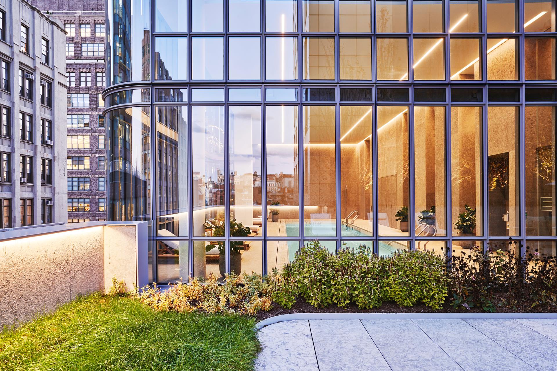 565 Broome Street, Unit S28A Manhattan, NY 10013 - Photo 17 of 36 a view of a building with a garden