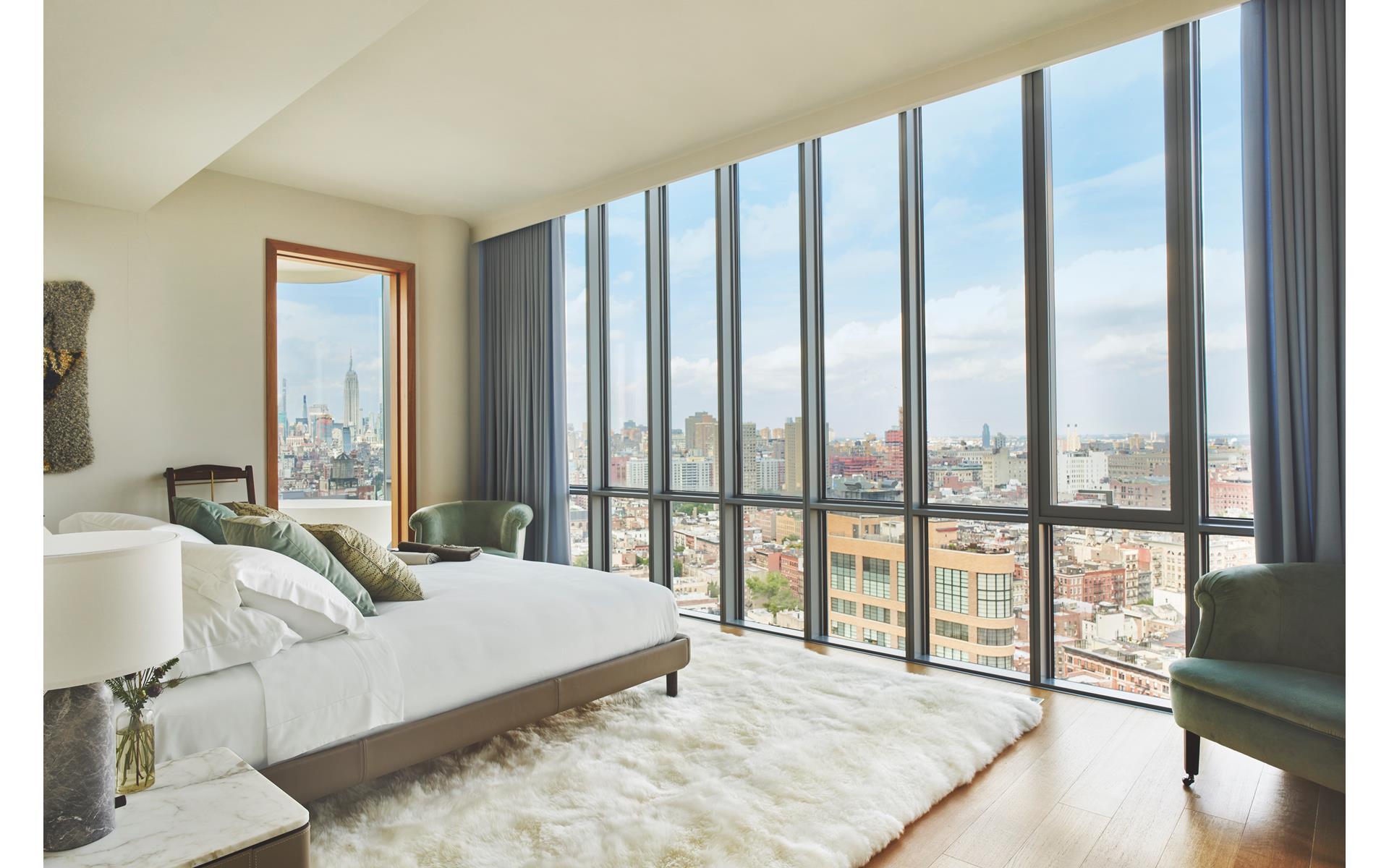 565 Broome Street, Unit S28A Manhattan, NY 10013 - Photo 4 of 36 a spacious bedroom with a large bed and a large window