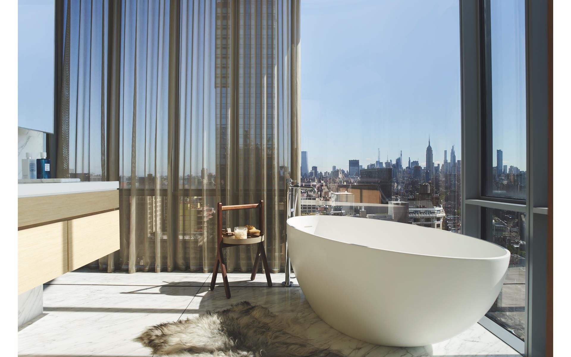 565 Broome Street, Unit S28A Manhattan, NY 10013 - Photo 6 of 36 a white bath tub sitting in front of a window