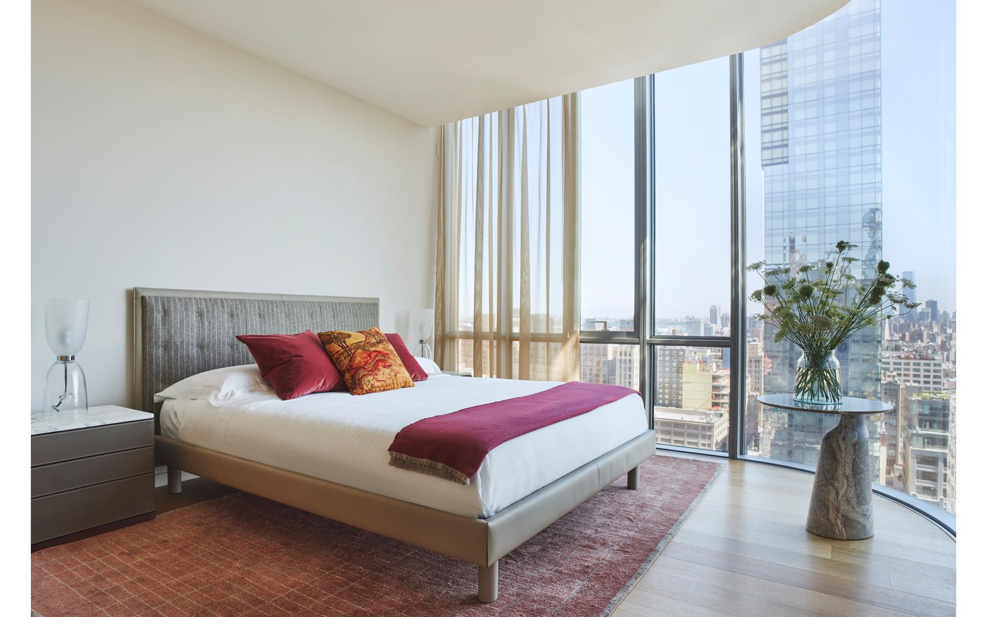 565 Broome Street, Unit S28A Manhattan, NY 10013 - Photo 8 of 36 a bedroom with a large bed and a potted plant