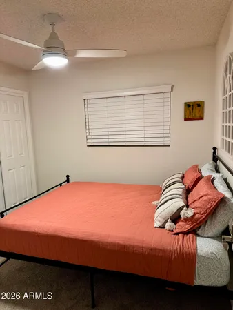 a bedroom with a bed and a table in it
